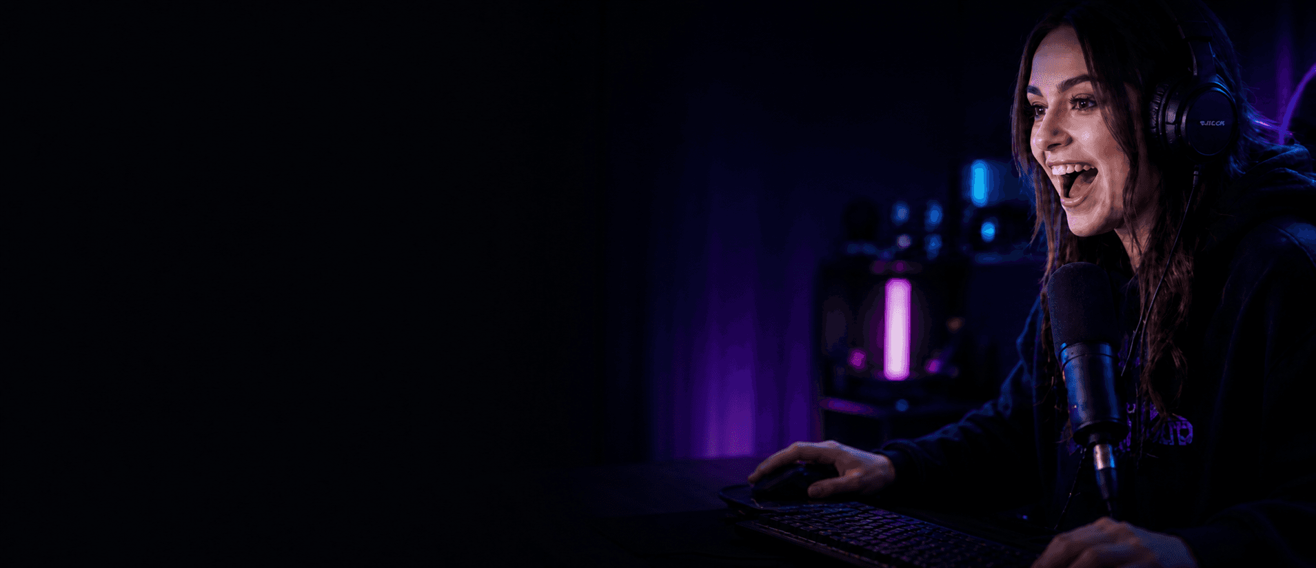 Streamer playing a game in a neon-lit studio