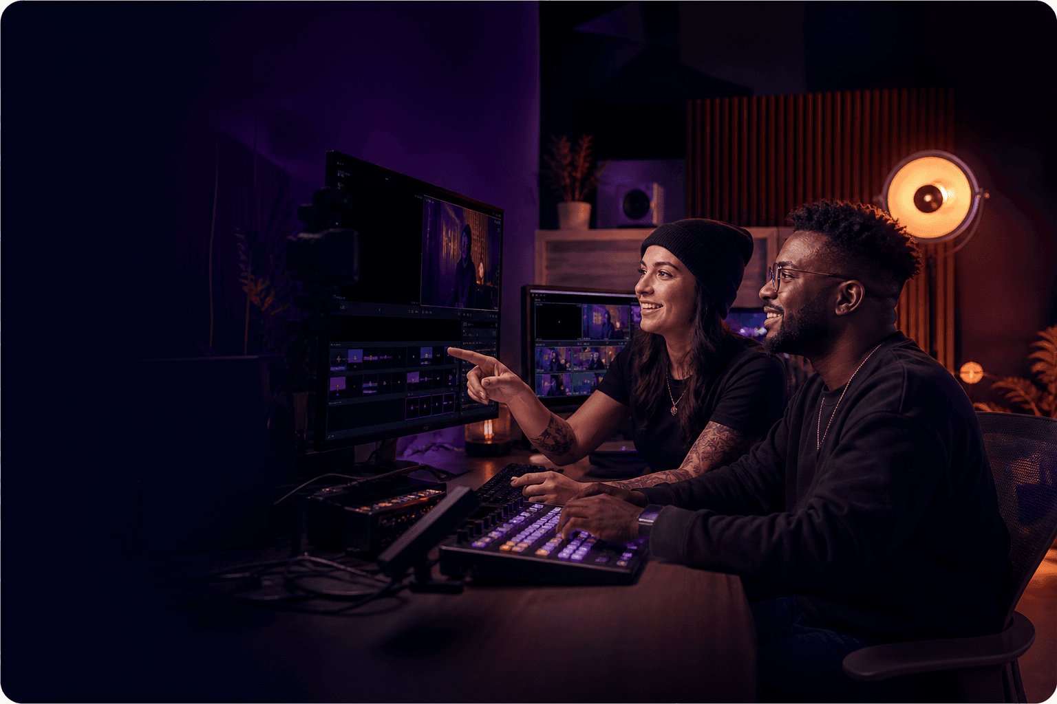 Two live production creators collaborating at a streaming studio desk